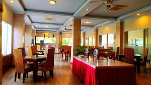 a dining room with tables and chairs in a restaurant at Puri Saron Denpasar Hotel in Denpasar