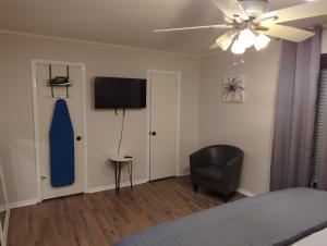 a bedroom with a bed and a blue surfboard on the wall at The Comfort Zone in Baton Rouge