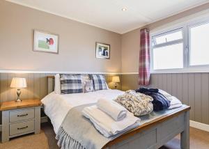 A bed or beds in a room at Pickering Lodges