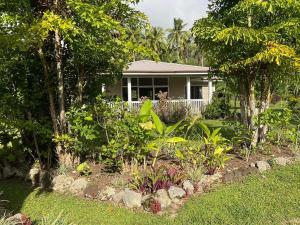 a house with a garden in front of it at Are'ora - the house for living in Rarotonga