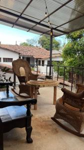 a wooden table and chairs on a patio at Donde Polo Hostal in Suchitoto