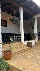 a patio with a table and potted plants on it at Donde Polo Hostal in Suchitoto