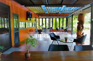 a restaurant with a table and chairs and a lot of windows at X Park Iskandar Puteri in Nusajaya