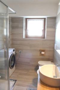 een badkamer met een toilet en een wasmachine bij 2 bedrooms apartement with wifi at Livigno in Livigno