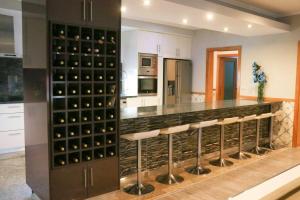 a kitchen with a wine cellar with a bunch of wine bottles at 4 bedrooms villa with private pool jacuzzi and terrace at Rebordoes Souto in Rebordões