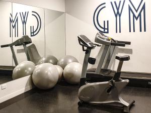 a gym with two exercise bikes in front of a mirror at Brisbane Luxury Gabba Apartment in Brisbane