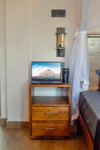 a television on a dresser in a bedroom at Kian's Place in Matara