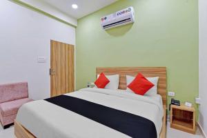 a bedroom with a bed and a air conditioner on the wall at Super Collection O Hotel Roxas in Jaipur