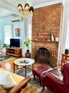 a living room with a couch and a fireplace at Charming heritage house in the heart of the city in Brisbane