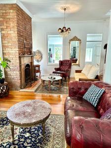 sala de estar con sofá y chimenea en Charming heritage house in the heart of the city en Brisbane