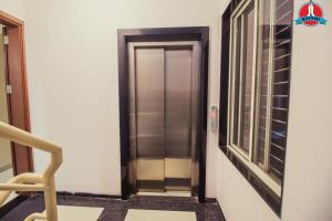 a elevator in a building with a window at Atithi Service Apartment in Pune