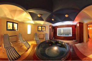 a large room with a bath tub in the middle at Hotel BAST Wellness & SPA in Inowrocław
