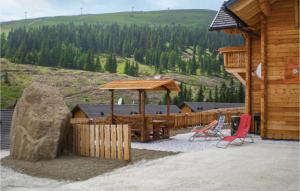 a wooden cabin with a table and chairs on a patio at Ferienhaus Mit Sauna in Lachtal