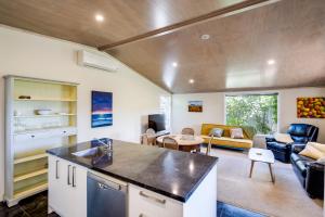 a kitchen and living room in a house at Garden Retreat - Napier Holiday Home in Napier