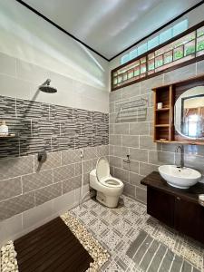 a bathroom with a toilet and a sink at Bunaken Villa Queen's Dive in Manado