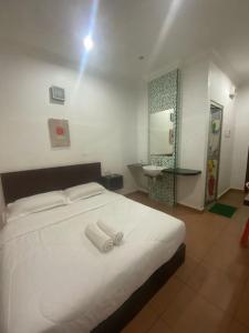 um quarto com uma cama com duas toalhas em UMMUL MOTEL CMART em Arau