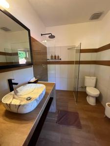 a bathroom with a large sink and a toilet at Luxury Apartment at Lipah Beach in Ambat