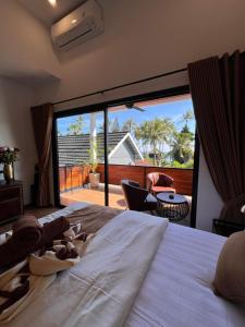 a bedroom with a bed with a view of a patio at Luxury Apartment at Lipah Beach in Ambat