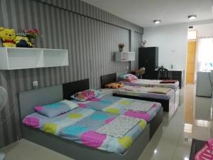 two beds sitting in a room with at CY Homestay in Kampar