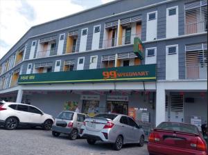 a building with cars parked in front of it at CY Homestay in Kampar