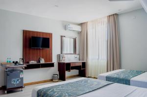Postel nebo postele na pokoji v ubytování La Fattoria Resort
