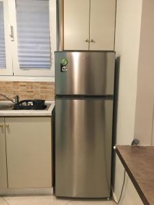 a stainless steel refrigerator in a kitchen at George's Apartment in Volos