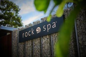 a sign for rock spa on a fence at Hard Rock Hotel Penang in Batu Ferringhi