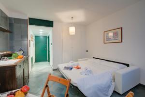 a bedroom with a bed and a kitchen with a sink at Fiori di Miele - Happy Rentals in Bardonecchia