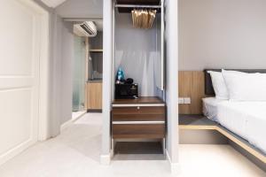 a bedroom with a bed and a nightstand next to a bed at NEWLY REFURBISHED - Heritage Collection on Ann Siang in Singapore