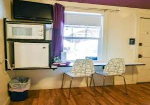 a kitchen with a table and two chairs and a microwave at Starry Night Memories in Moab