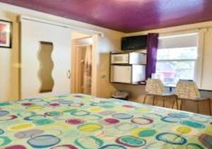 a bedroom with a bed with a colorful bedspread at Starry Night Memories in Moab