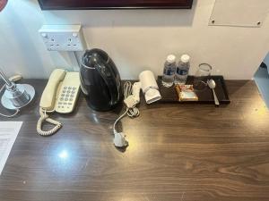 a desk with a phone and other items on it at KINGSMAN BOUTIQUE HOTEL in Kota Kinabalu +13 photos