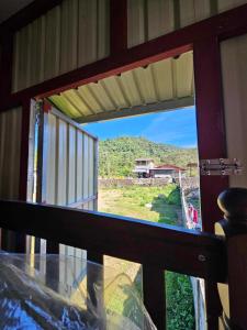 a room with a window with a view of a mountain at Nangalisan Liliz Lee Private Resort and Accomodation 