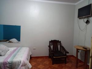 En eller flere senge i et værelse på Hospedaje TOSCANO SUITES