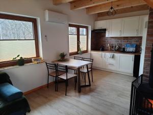 a kitchen with a table and chairs in a room at Domki nad potokiem in Stary Sącz +16 photos
