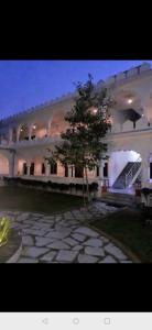 a large building with a tree in front of it at Hotel Third Eye in Pushkar