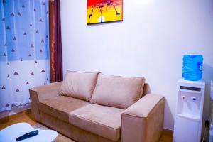 ein Wohnzimmer mit einem Sofa und einem Tisch in der Unterkunft Havana Apartments-South B in Nairobi