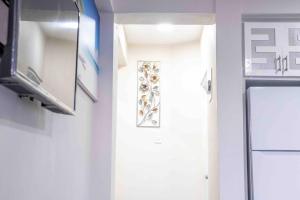 a room with a door with a window and a tv at Royal Bliss Apartment Suites in Kingstown