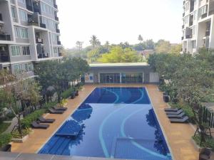 an overhead view of a swimming pool in a building at Central Comfy Airy Tidy Apartment in Udon Thani