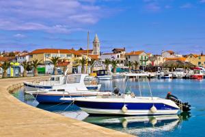 a boat is docked at a dock in a harbor at Mobilehome Mali No 2 in Pakoštane