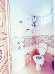 a bathroom with a white toilet in a room at Hotel shivangi ECO in Puri