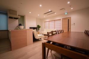 a living room with a table and a dining room at Ryoan / Vacation STAY 80251 in Otaru