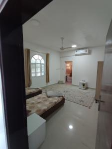 a large room with a bed and a living room at The best room for peace of mind in Muscat