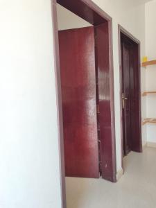 an open door in a room with two doors at The best room for peace of mind in Muscat