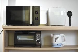 a microwave and a coffee maker on a shelf at Ryoan / Vacation STAY 80261 in Otaru
