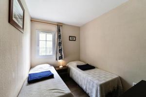 ein kleines Zimmer mit zwei Betten und einem Fenster in der Unterkunft Village Moliets - maeva Home - Maison 3 pièces 6 personnes Selection MAE-2003 in Moliets-et-Maa + 23 Fotos