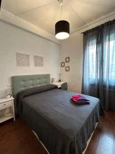 a bedroom with a large bed and a window at Habitaciones Magdalena in Madrid