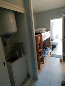 a room with a closet with a bed in it at Appartement T2 cabine, capacité 4 personnes, à 600 m de la plage et à 300 m du Golf in Moliets-et-Maa