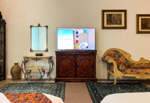 a living room with a couch and a chair and a table at Peranakan Suites Georgetown in George Town