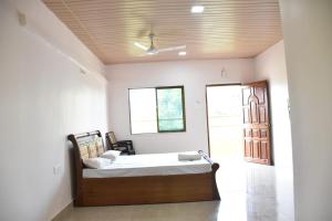 a bedroom with a bed in a room at Comforts Stays Kihim in Kīhīm